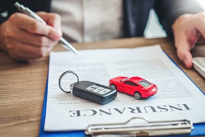 car insurance paperwork with car keys on top
